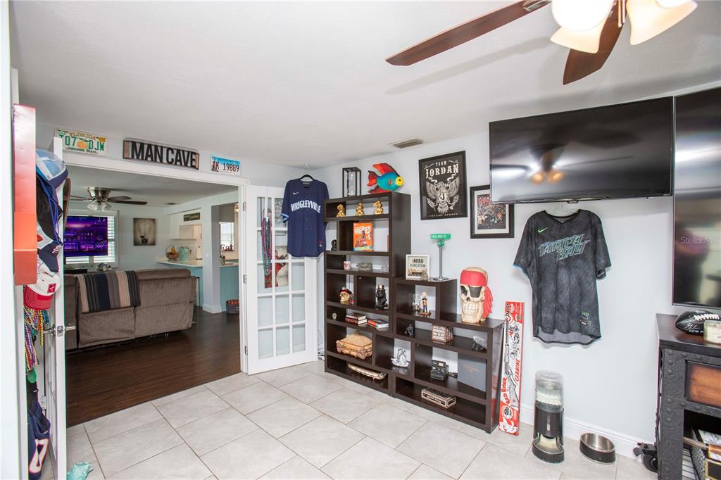 5240 School Road New Port Richey, FL 34653 - Photo 24 of 32 a bedroom with furniture and a flat screen tv