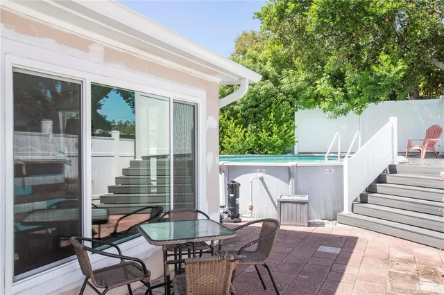 a balcony with table and chairs