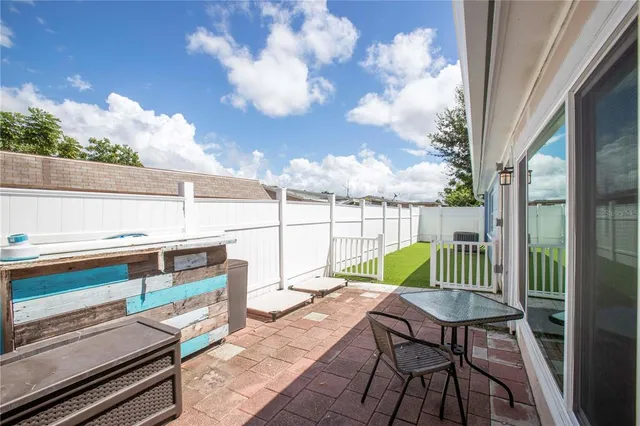 a view of balcony with wooden floor and outdoor seating