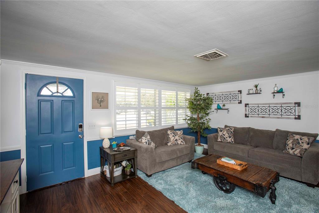 5240 School Road New Port Richey, FL 34653 - Photo 4 of 32 a living room with furniture and wooden floor