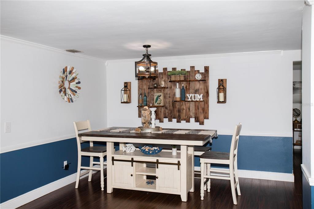 5240 School Road New Port Richey, FL 34653 - Photo 7 of 32 a dining room with a table and chairs