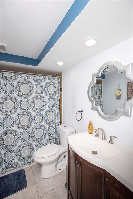 5240 School Road New Port Richey, FL 34653 - Photo 9 of 32 a bathroom with a sink a toilet and a mirror