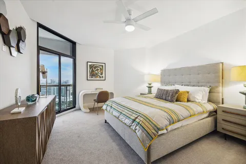 a bedroom with a bed and ceiling fan