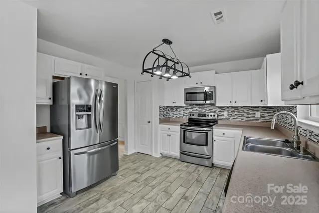 a kitchen with a refrigerator stove and microwave