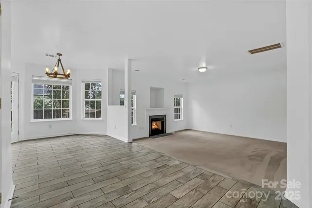 a view of a livingroom with a fireplace and window