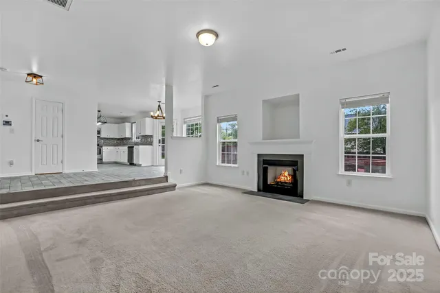 a view of a livingroom with a fireplace and a window