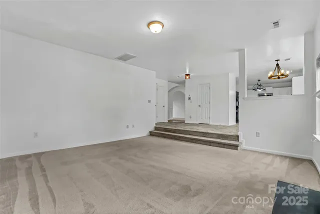 an empty room with a fireplace and window