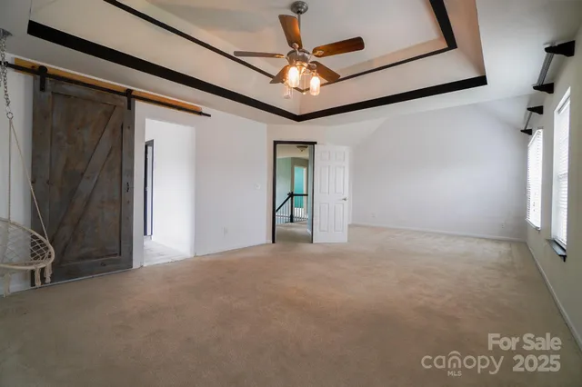 a view of a livingroom with a ceiling fan and window