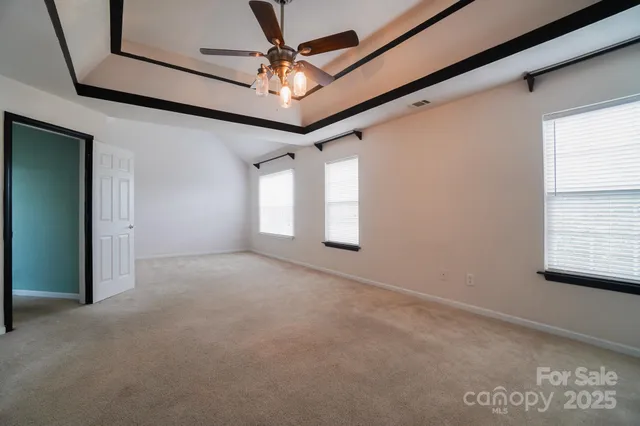 a view of a livingroom with a ceiling fan and window