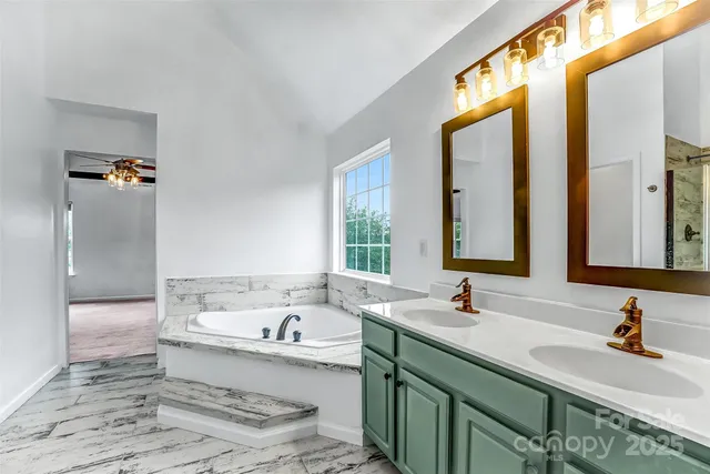 a bathroom with a bathtub and a window