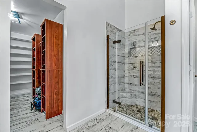 a view of walk in closet with empty racks