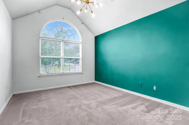 a view of a livingroom with a chandelier fan