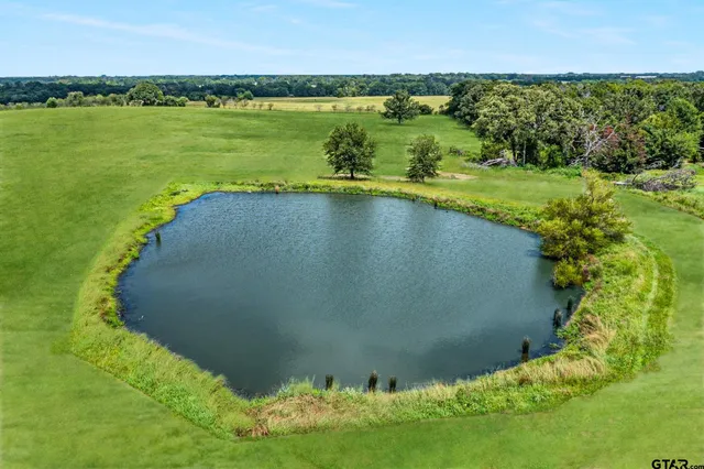 a view of a golf course with an ocean