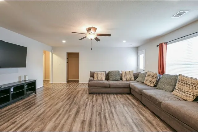 a living room with furniture and a flat screen tv