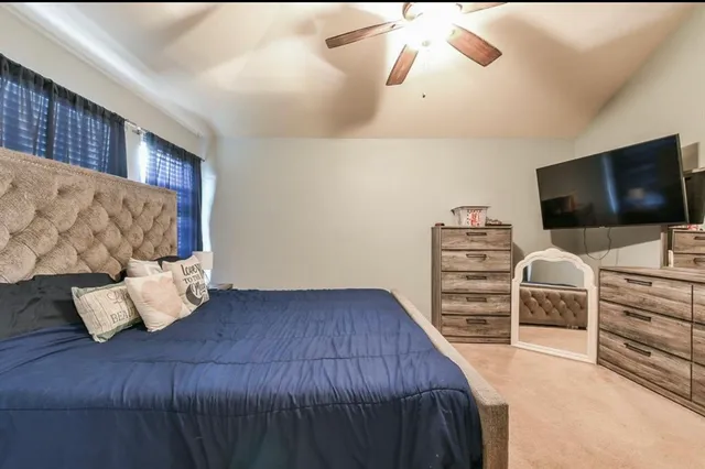 a bedroom with furniture and a flat screen tv