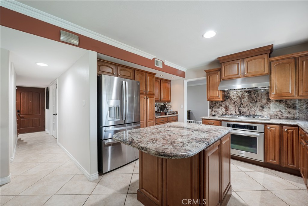 2203 Homewood Avenue Simi Valley, CA 93063 - Photo 5 of 37 a kitchen with stainless steel appliances granite countertop a sink stove and refrigerator