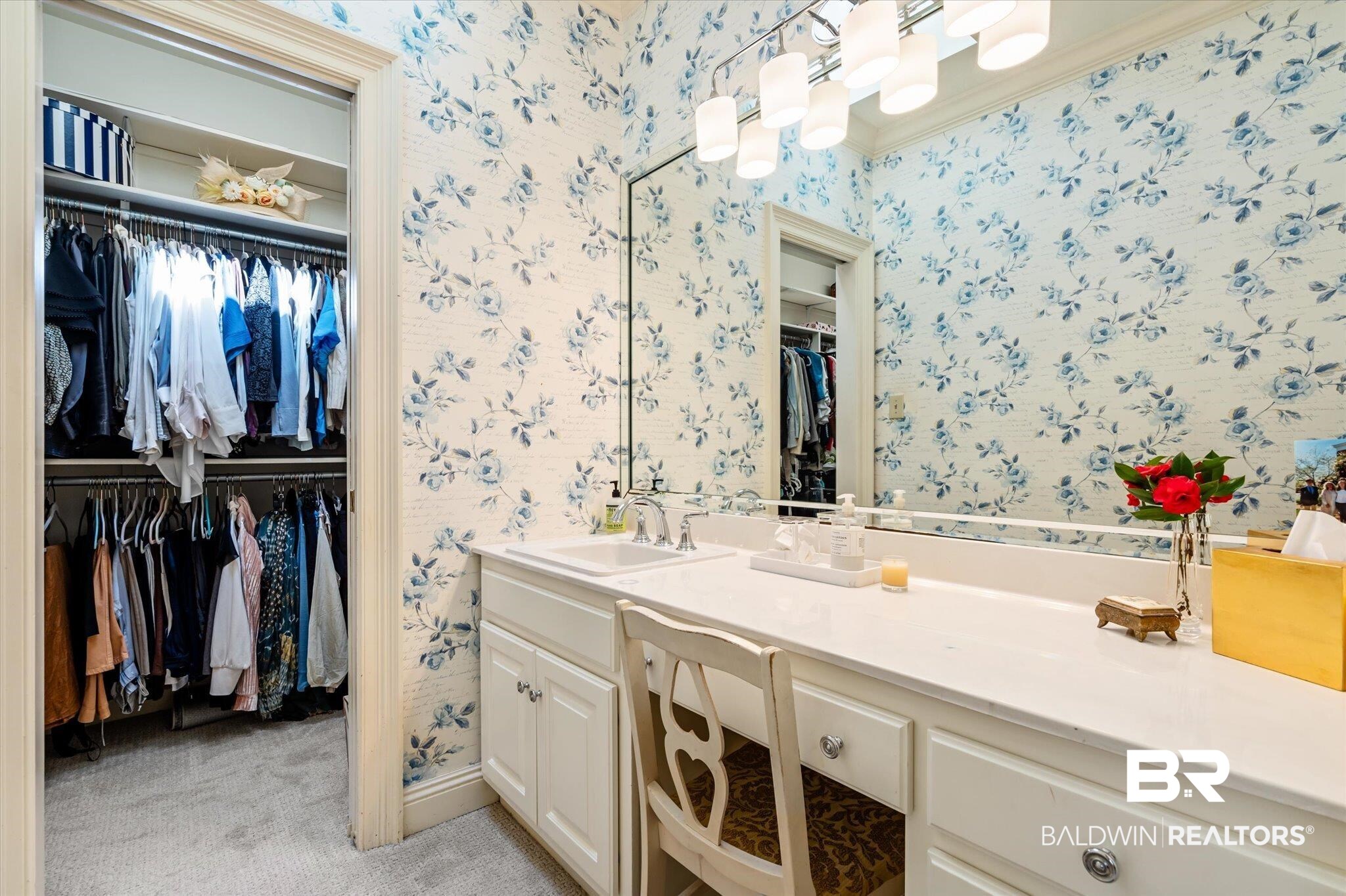 4 Kingsway Mobile, AL 36608 - Photo 22 of 44 Bathroom with baseboards, a spacious closet, vanity, and wallpapered walls