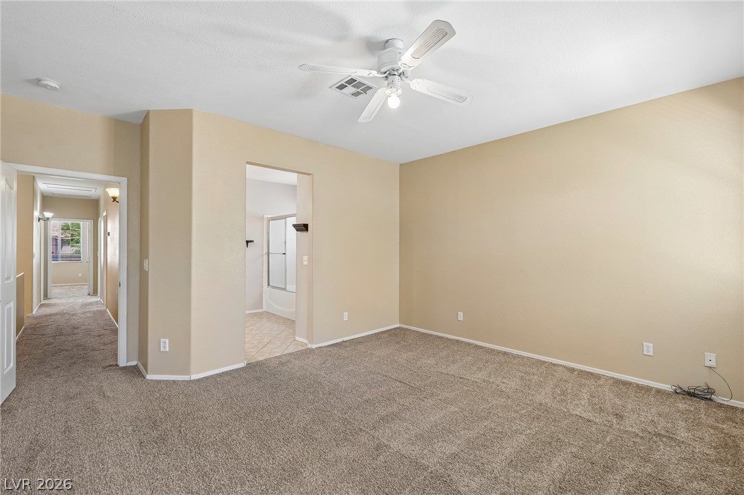 1727 Millstream Way Henderson, NV 89074 - Photo 26 of 46 A spacious bedroom offers comfort and a tranquil atmosphere for relaxation.