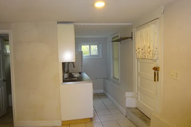 a kitchen with a refrigerator and a stove