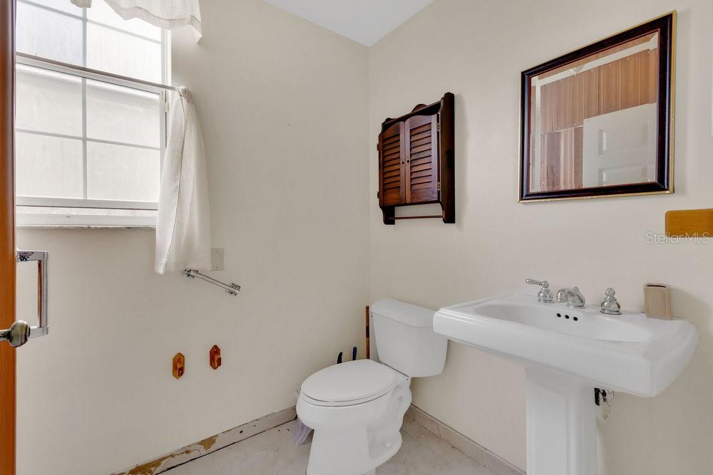 4110 Santa Barbara Road Kissimmee, FL 34746 - Photo 11 of 32 a bathroom with a toilet sink and mirror