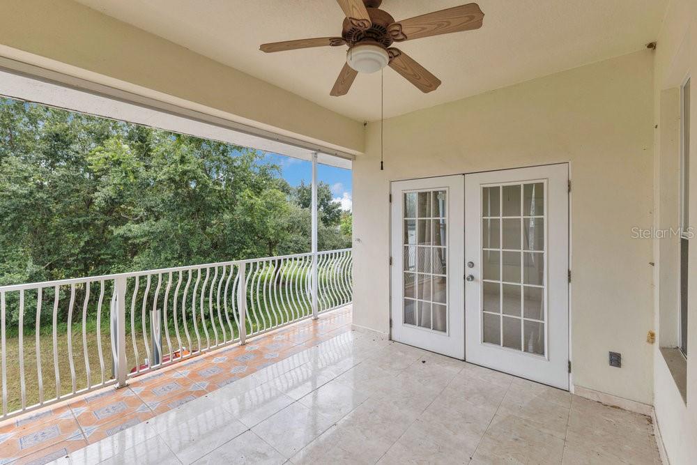 4110 Santa Barbara Road Kissimmee, FL 34746 - Photo 13 of 32 a view of a balcony with a ceiling fan