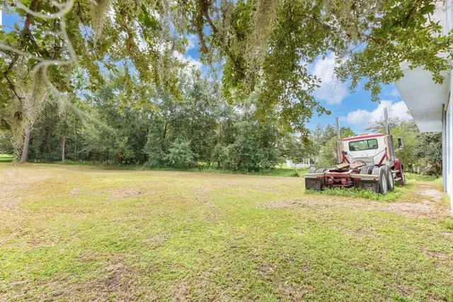 a view of house with yard