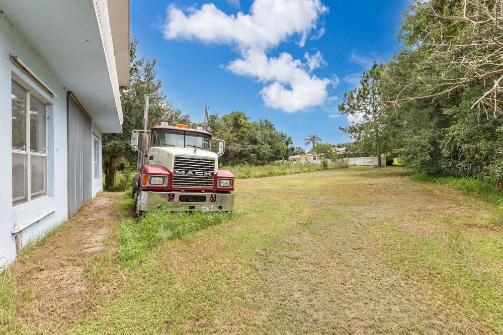 4110 Santa Barbara Road Kissimmee, FL 34746 - Photo 20 of 32 a view of a house with a yard and sitting area