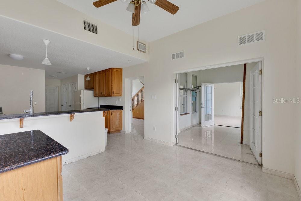 4110 Santa Barbara Road Kissimmee, FL 34746 - Photo 28 of 32 a kitchen with stainless steel appliances granite countertop a refrigerator and a sink