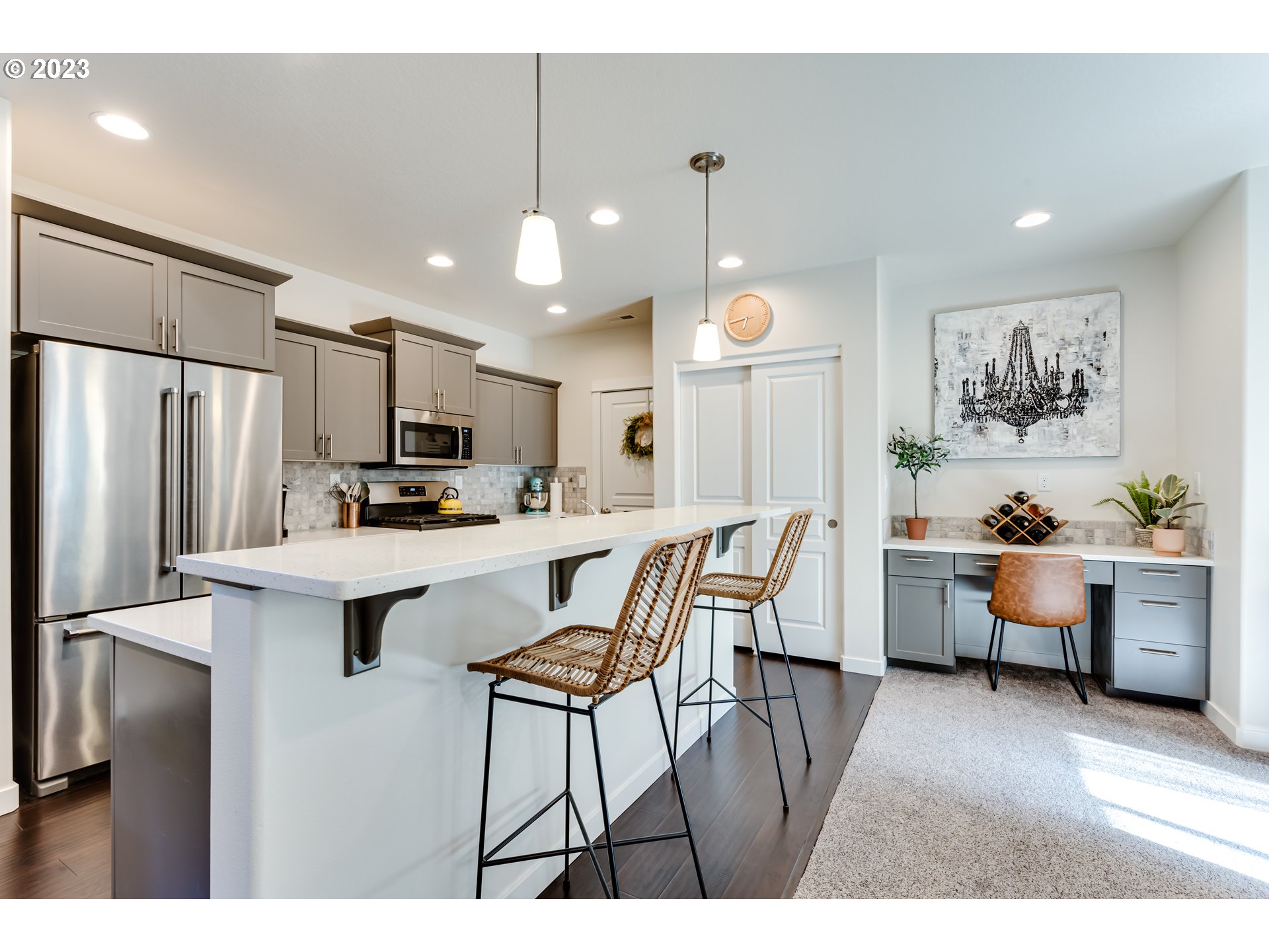 660 Fox Pine Lane Eugene, OR 97405 - Photo 11 of 48 a kitchen with stainless steel appliances kitchen island granite countertop a refrigerator a stove a sink a dining table and chairs with wooden floor