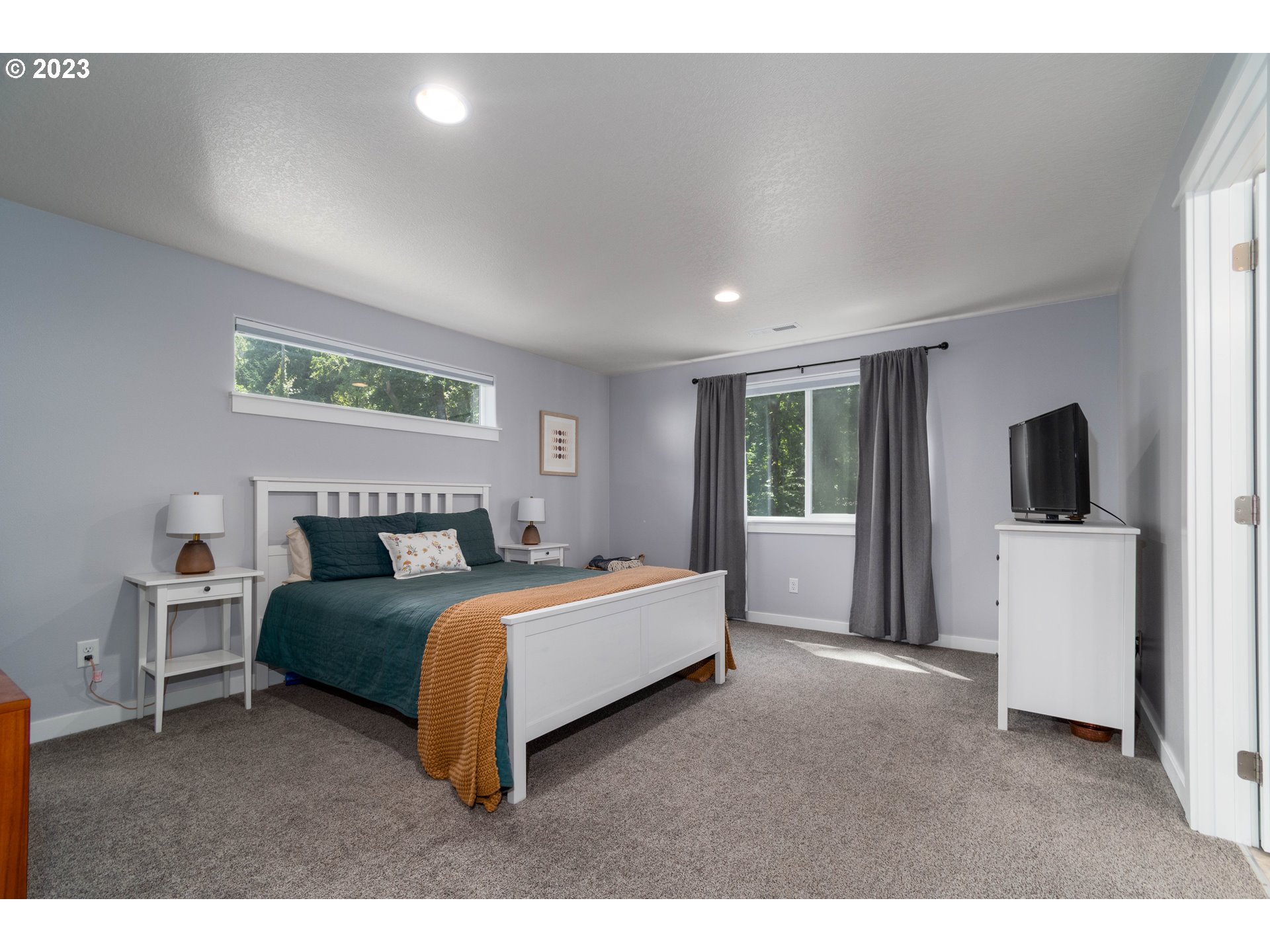 660 Fox Pine Lane Eugene, OR 97405 - Photo 21 of 48 a spacious bedroom with a bed and a couch