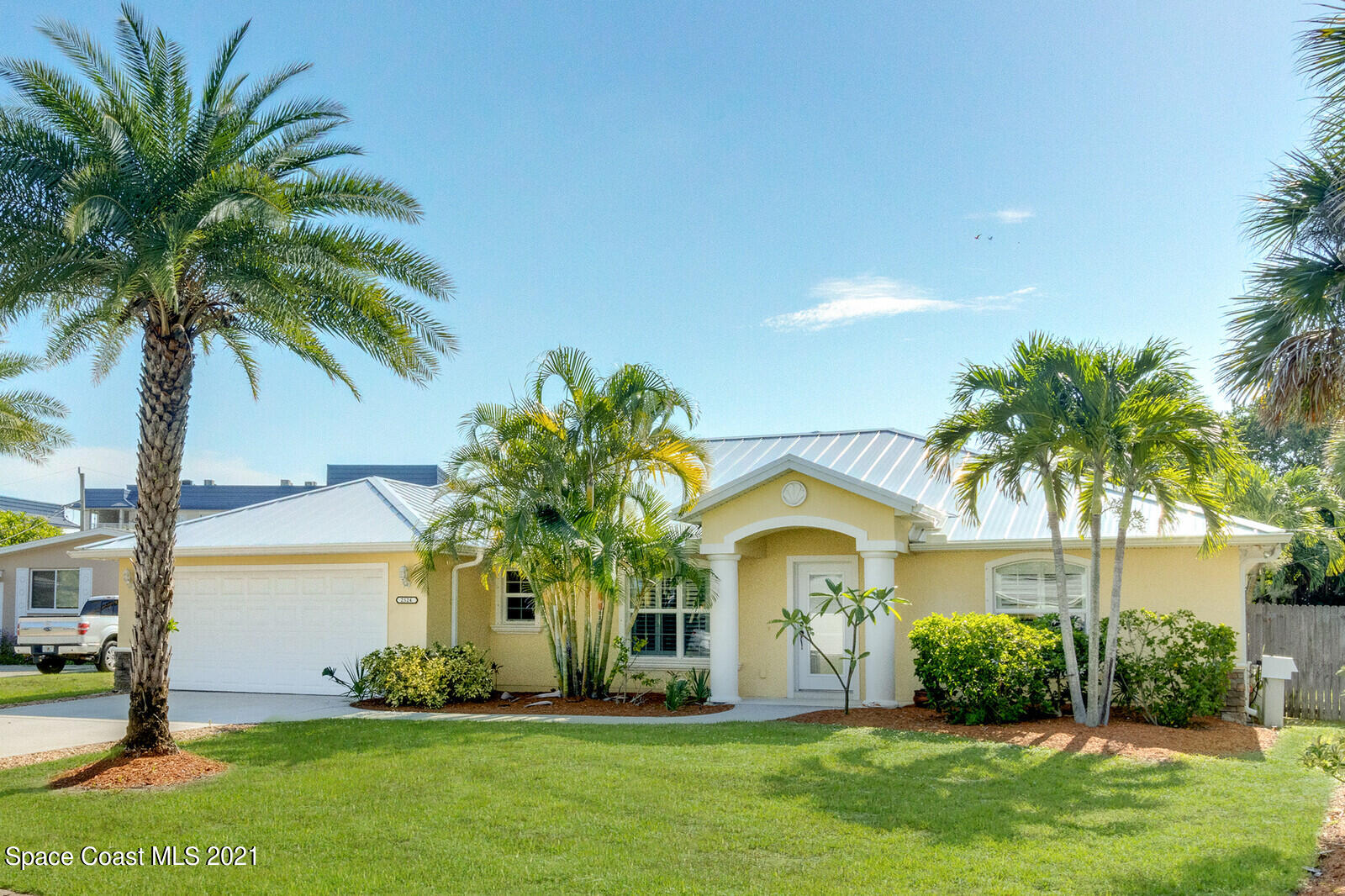 2524 Carmel Road Indialantic, FL 32903 - Photo 1 of 30 a front view of a house with a garden
