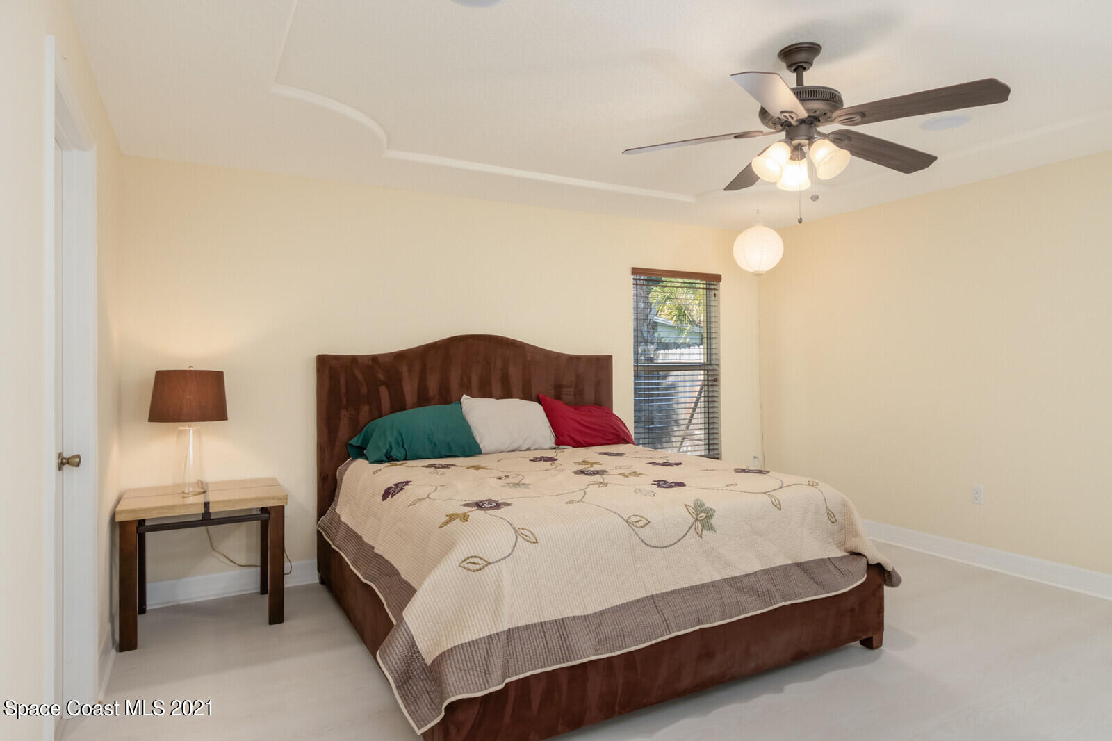 2524 Carmel Road Indialantic, FL 32903 - Photo 14 of 30 a bedroom with a bed and a chandelier