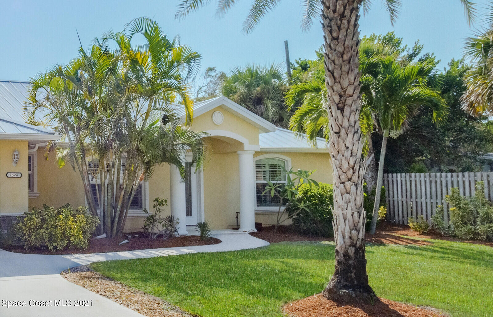 2524 Carmel Road Indialantic, FL 32903 - Photo 29 of 30 a front view of a house with a yard and potted plants