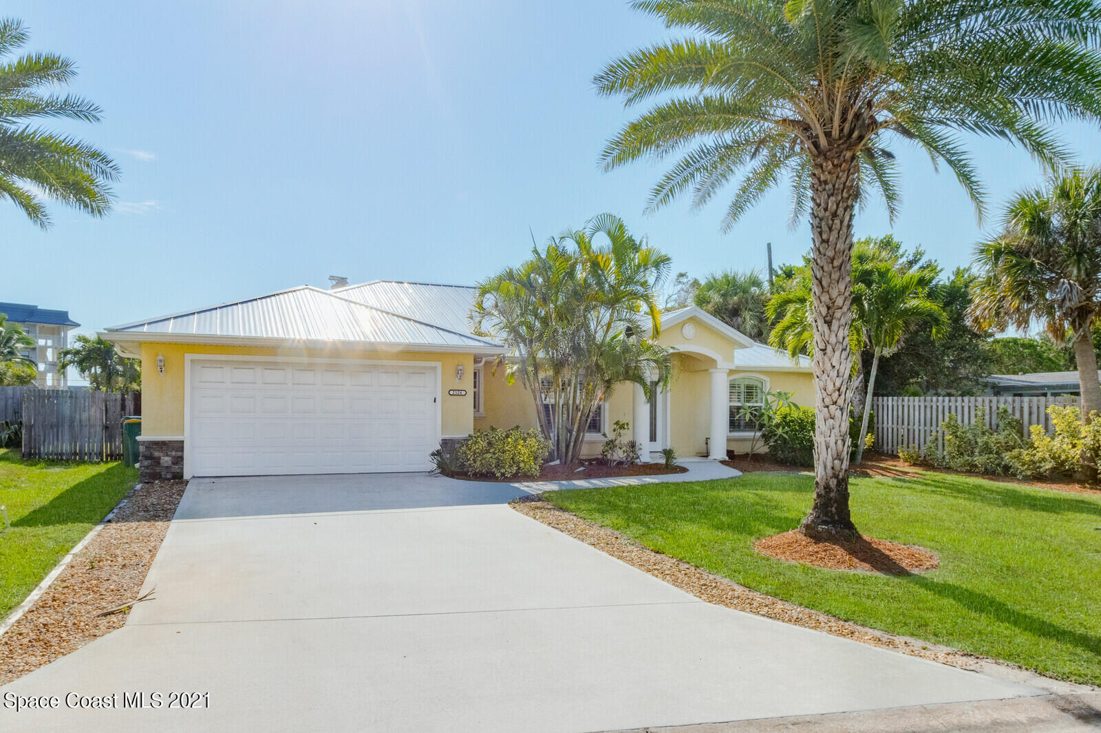 2524 Carmel Road Indialantic, FL 32903 - Photo 30 of 30 a front view of a house with a yard and potted plants