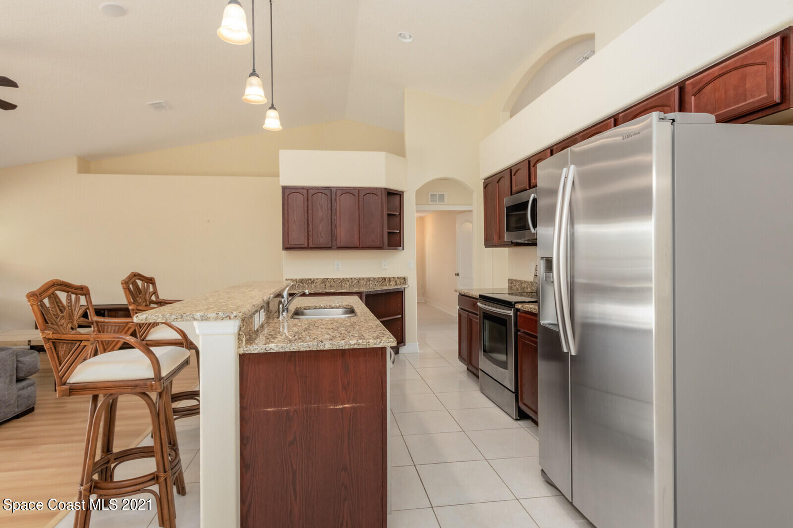 2524 Carmel Road Indialantic, FL 32903 - Photo 6 of 30 a kitchen with stainless steel appliances granite countertop a refrigerator and a stove top oven
