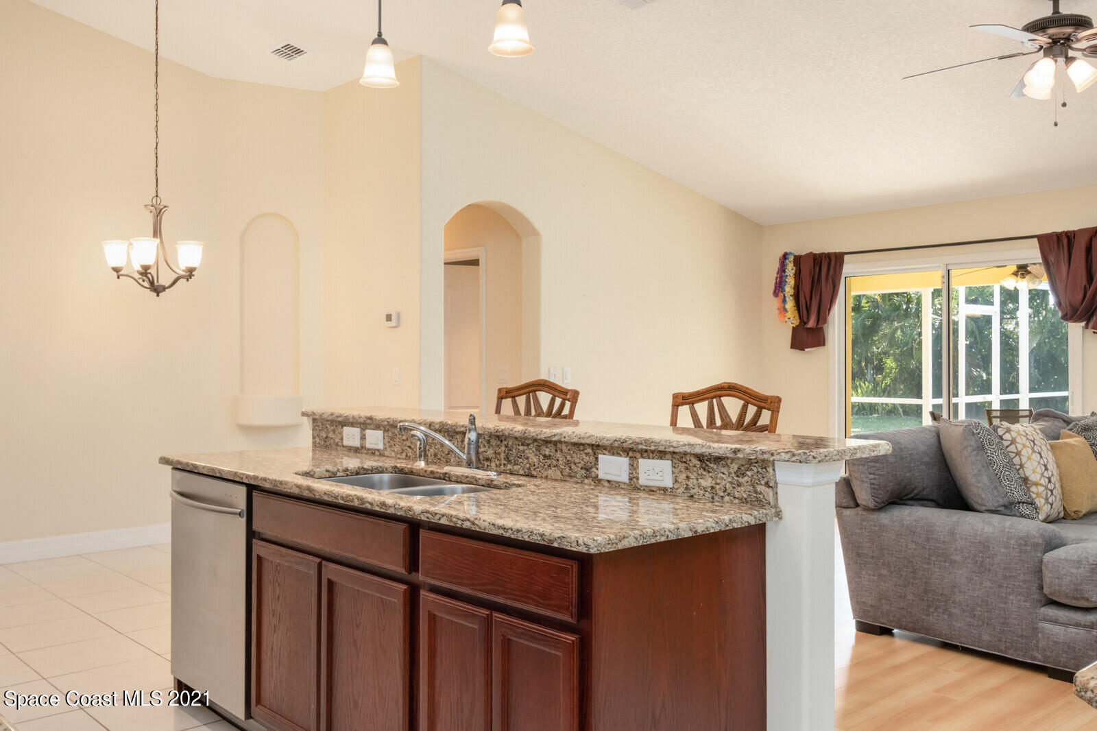 2524 Carmel Road Indialantic, FL 32903 - Photo 7 of 30 a view of kitchen island with stainless steel appliances granite countertop furniture sink and wooden floor