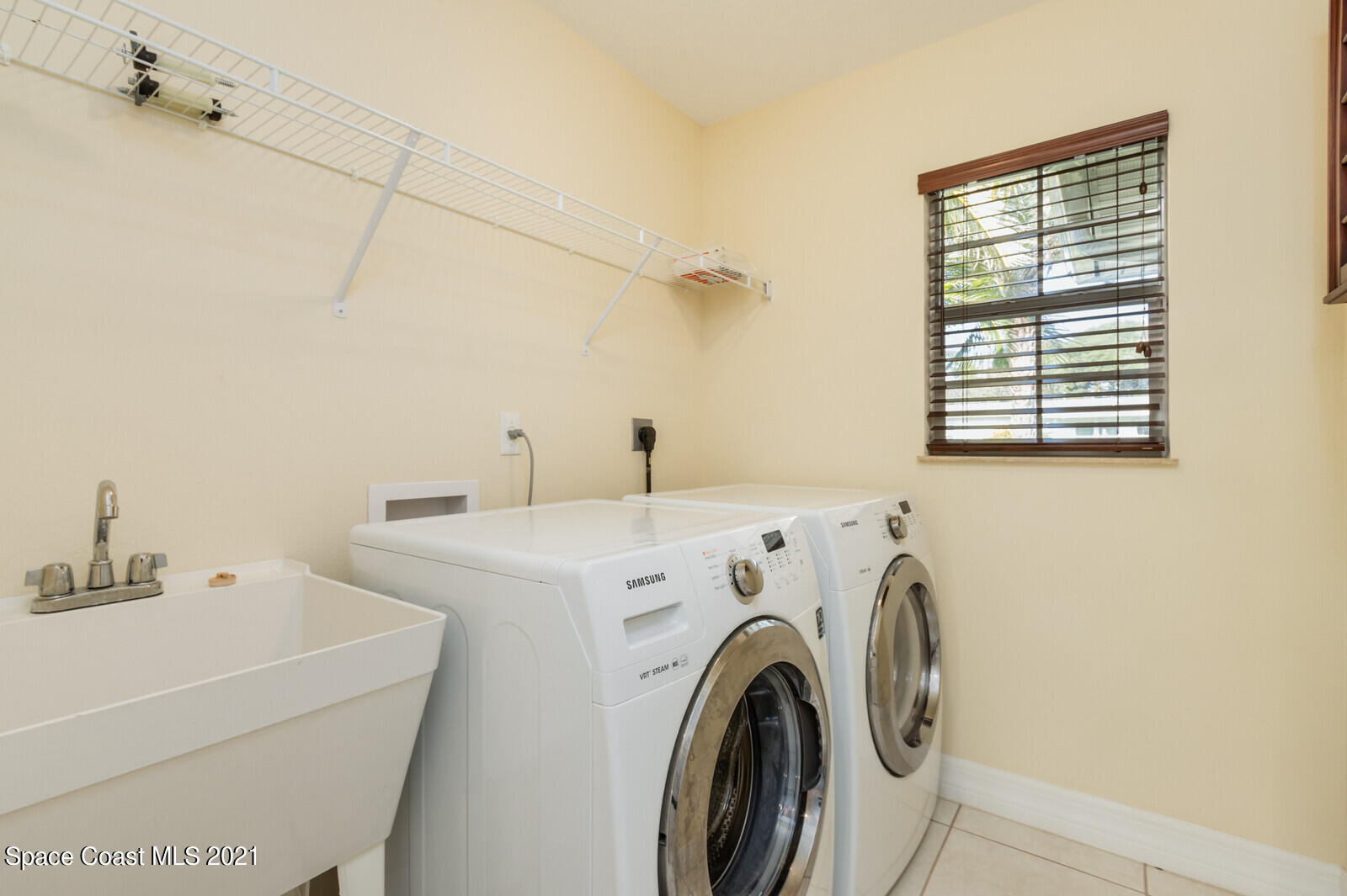 2524 Carmel Road Indialantic, FL 32903 - Photo 9 of 30 a utility room with dryer and washer