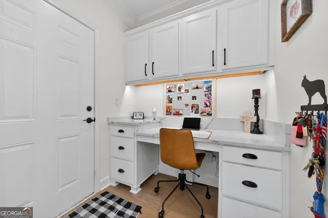 a kitchen with a cabinets and wooden floor