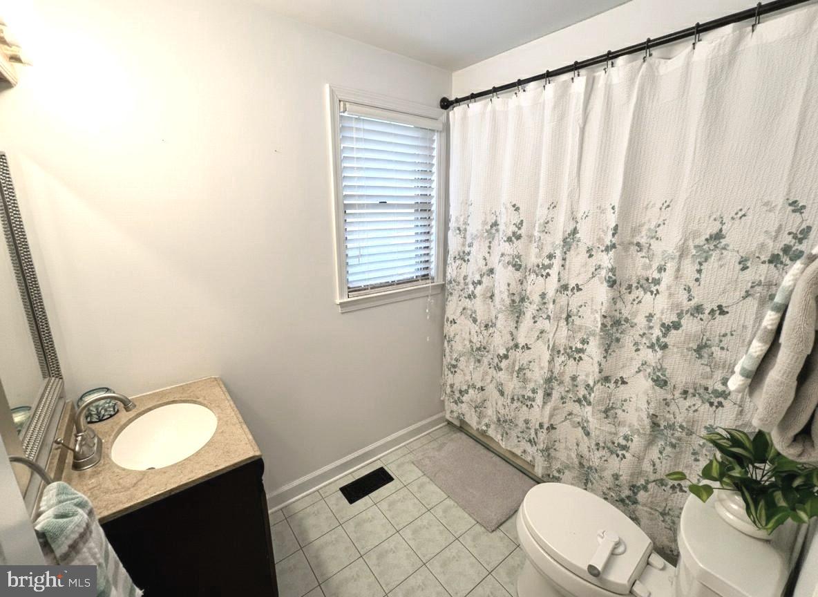 10680 Allens Fresh Road Charlotte Hall, MD 20622 - Photo 14 of 22 a bathroom with a granite countertop toilet and a sink