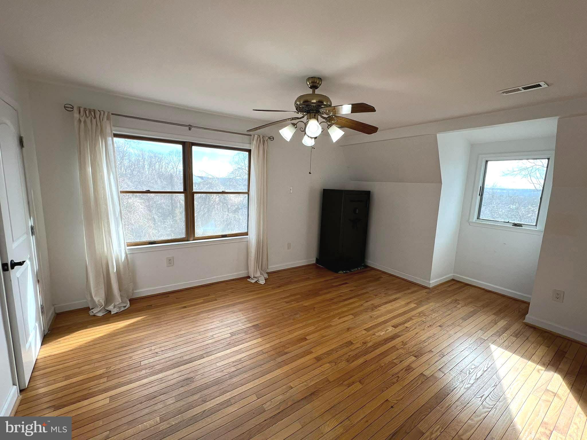 10680 Allens Fresh Road Charlotte Hall, MD 20622 - Photo 15 of 22 a view of an empty room with a window and wooden floor