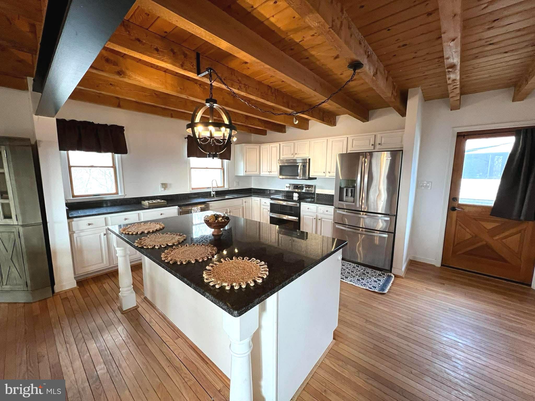 10680 Allens Fresh Road Charlotte Hall, MD 20622 - Photo 10 of 22 a kitchen with stainless steel appliances granite countertop a sink a stove and a refrigerator