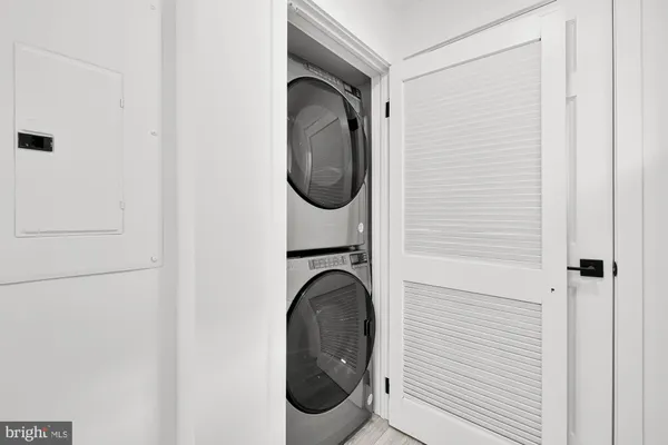 a close view of a utility room with dryer and washer
