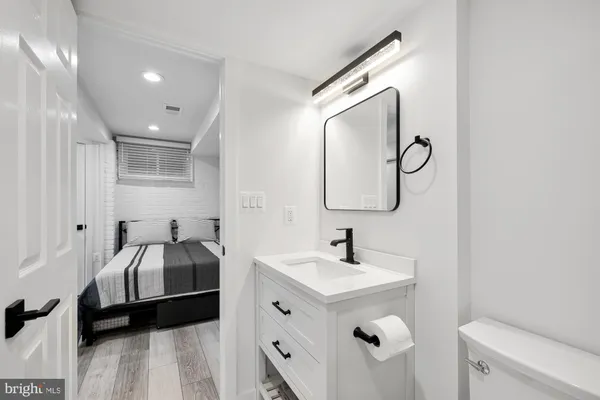 a en suite bathroom with a double vanity sink and a mirror
