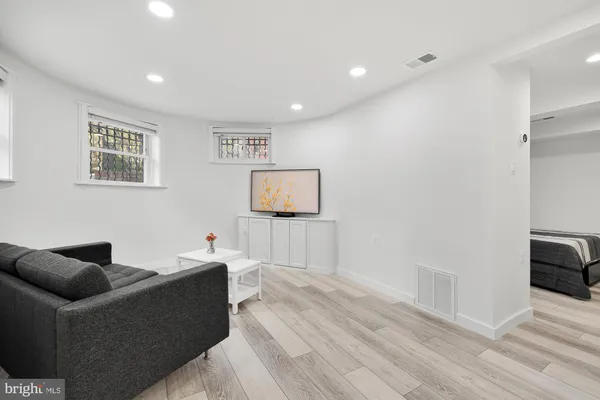 a living room with furniture and a wooden floor
