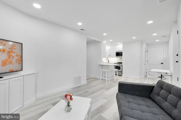a living room with furniture and kitchen view