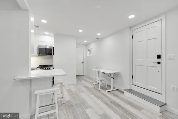 a view of kitchen with sink microwave and cabinets