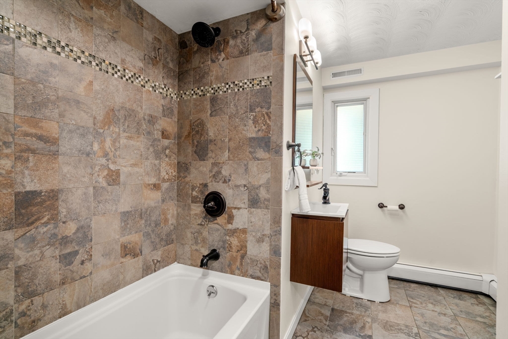 51 Griffin Road Framingham, MA 01701 - Photo 14 of 29 a bathroom with a bathtub and a toilet