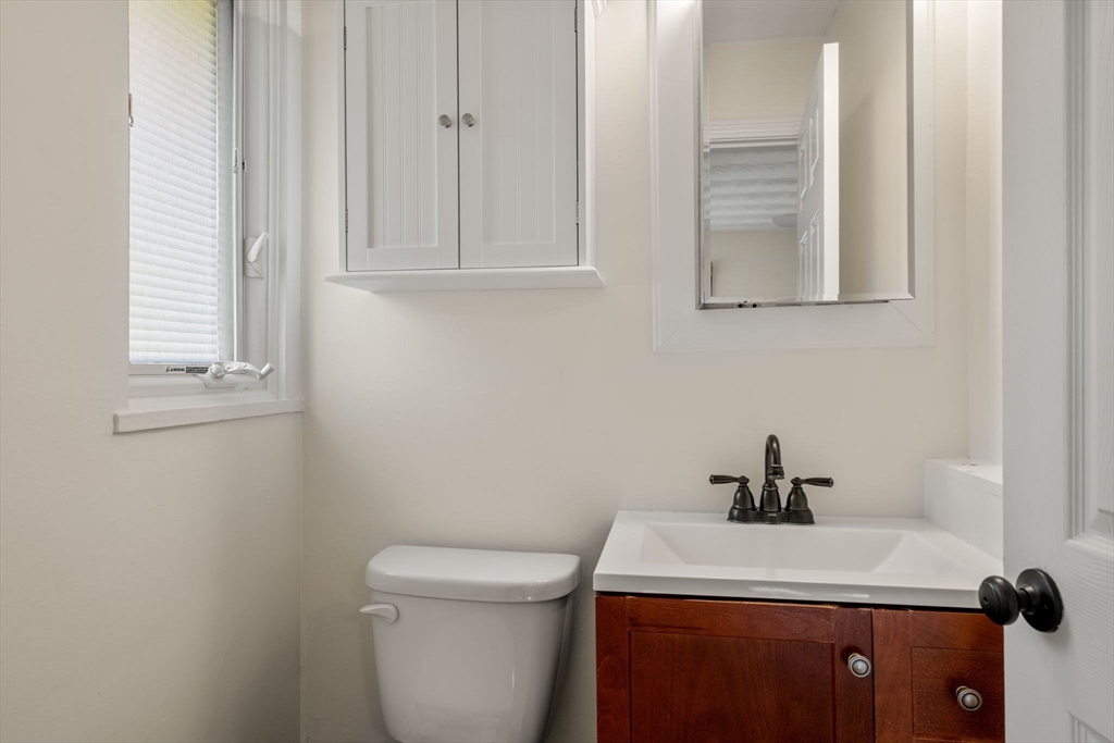 51 Griffin Road Framingham, MA 01701 - Photo 18 of 29 a bathroom with a toilet sink and mirror