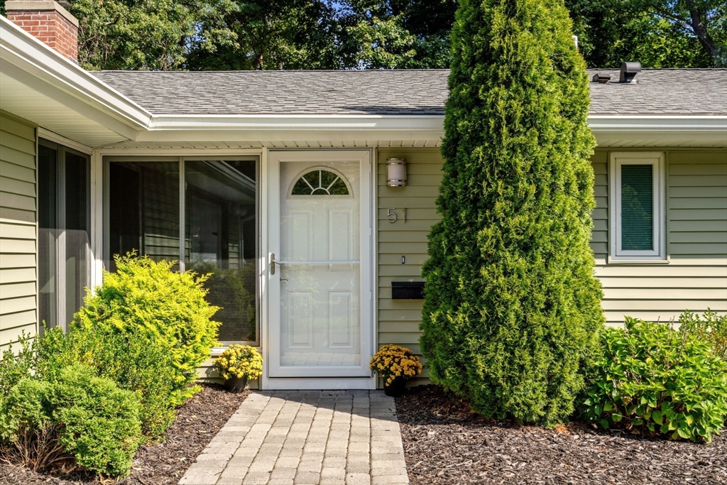 51 Griffin Road Framingham, MA 01701 - Photo 23 of 29 a front view of a house with a blue garage