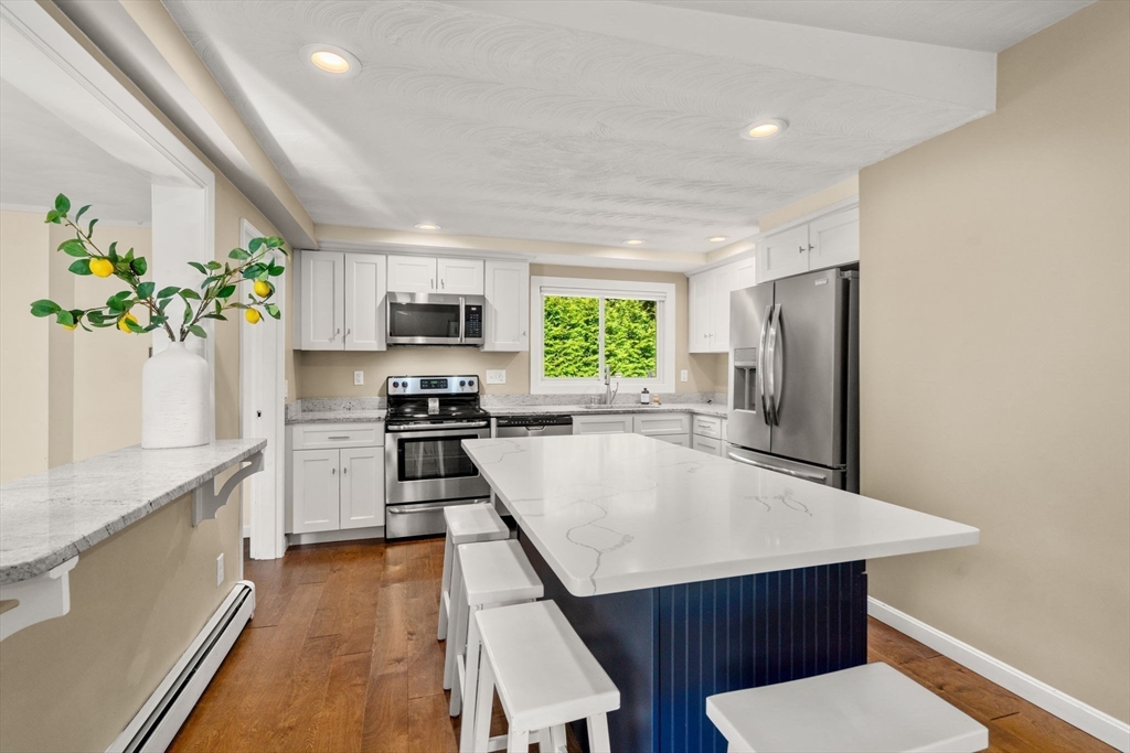 51 Griffin Road Framingham, MA 01701 - Photo 8 of 29 a kitchen with granite countertop stainless steel appliances a stove top oven a sink a counter space and cabinets